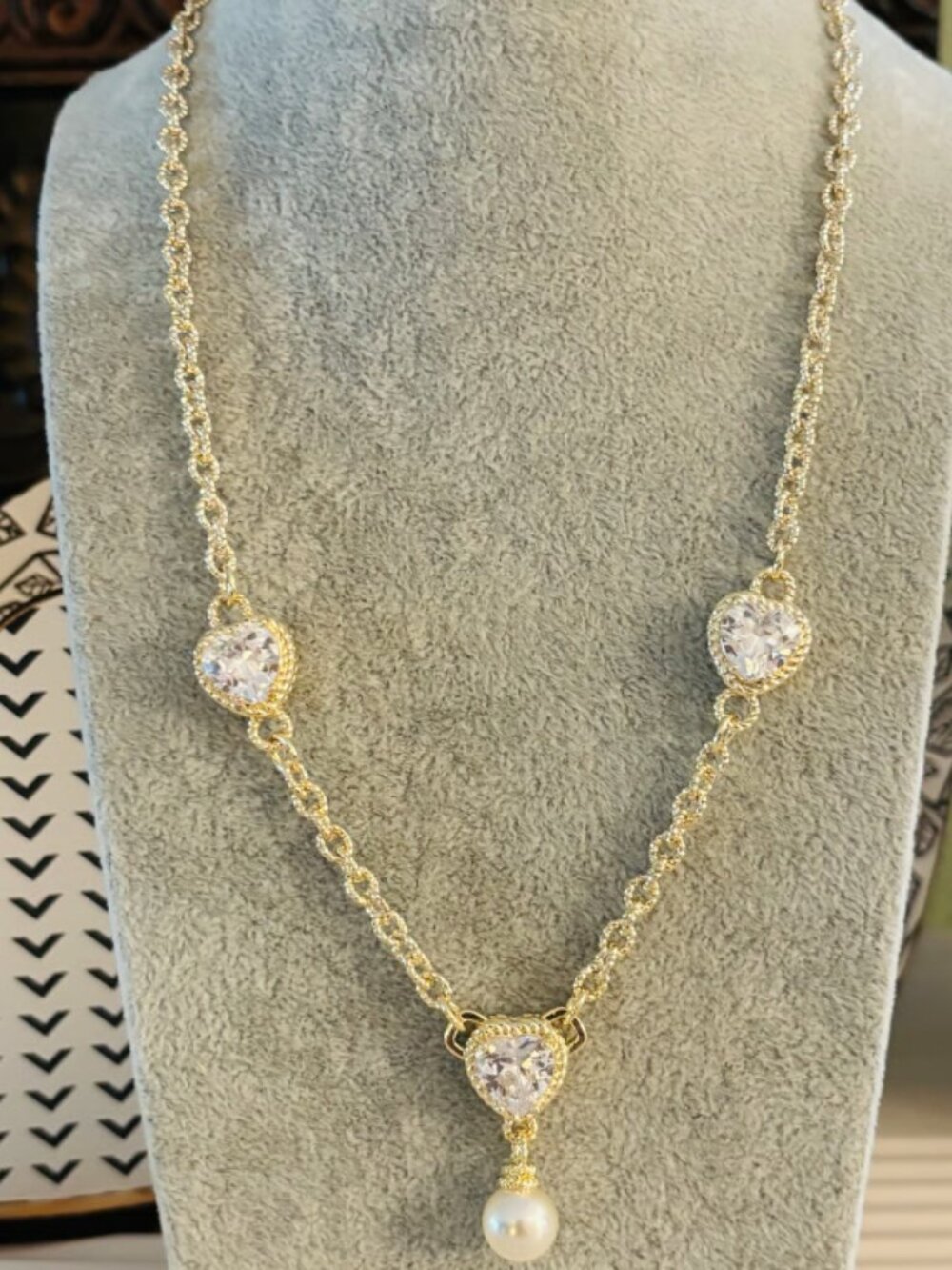 Gold tone necklace with CZ heart charms and pearl pendant